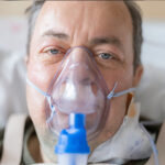 stone worker wearing an oxygen mask