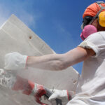 artificial stone worker being covered in dangerous stone dust as he grinds