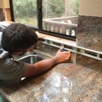 worker installing a stone coutnertop