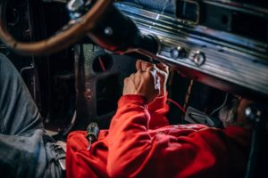 mechanic working on the inside of a car
