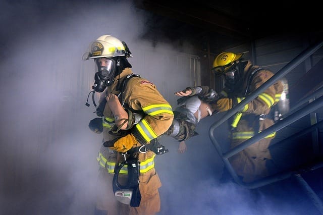 fireman going into a burning building with smoke