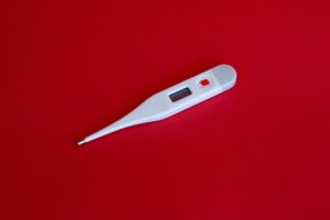 digital thermometer on a red background