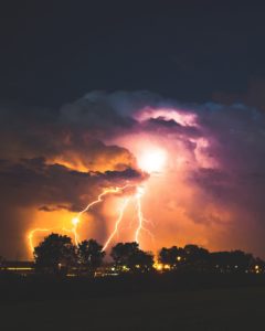 lightning striking trees during a storm