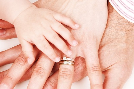 baby hand on parents hands