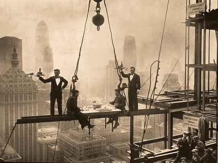 men standing on a beam in the air