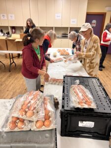 group of people packing eggs for food bank